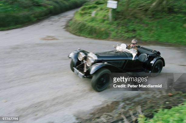 Conservative politician Alan Clark driving his Jaguar SS100 sports car near his home at Saltwood Castle, Kent, 16th April 1994.
