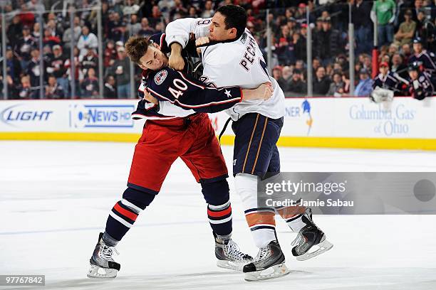 Jared Boll of the Columbus Blue Jackets is hit by Theo Peckham of the Edmonton Oilers during a fight in the first period on March 15, 2010 at...