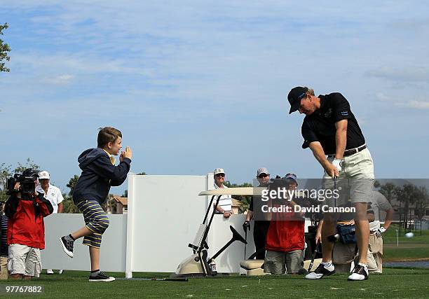 Ernie Els of South Africa watched by his son Ben during the Els for Autism Pro-Am on the Champions Course at the PGA National Golf Club on March 15,...