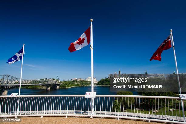 cityscape of otawa and flags over the ottawa river, ottawa, canada - ottawa landscape stock pictures, royalty-free photos & images