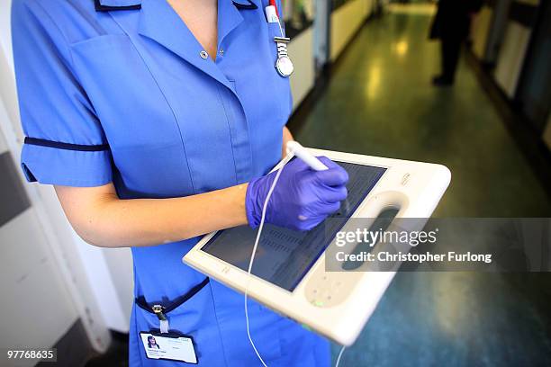 Nurse uses a wireless electronic tablet to order medicines from the pharmacy at The Queen Elizabeth Hospital on March 16, 2010 in Birmingham,...