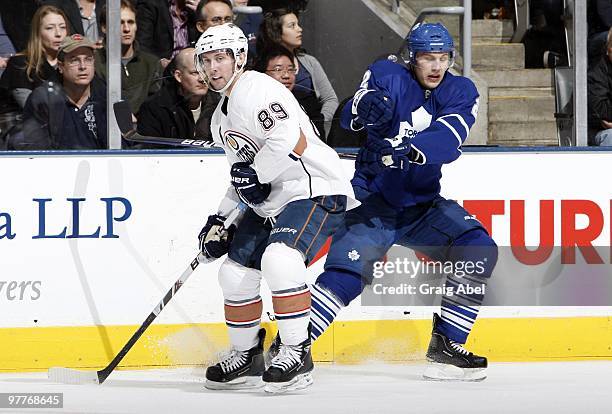 Luke Schenn of the Toronto Maple Leafs bumps Sam Gagner of the Edmonton Oilers during game action March 13, 2010 at the Air Canada Centre in Toronto,...