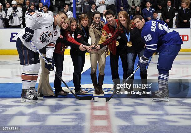 Olympians Tessa Bonhomme, Jayna Hefford, Tessa Virtue, Scott Moir, Becky Kellar and Heather Moyse drop the puck for Ethan Moreau of the Edmonton...