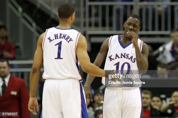 Xavier Henry and Tyshawn Taylor of the Kansas Jayhawks react in the second half while taking on the Texas Tech Red Raiders during the quarterfinals...