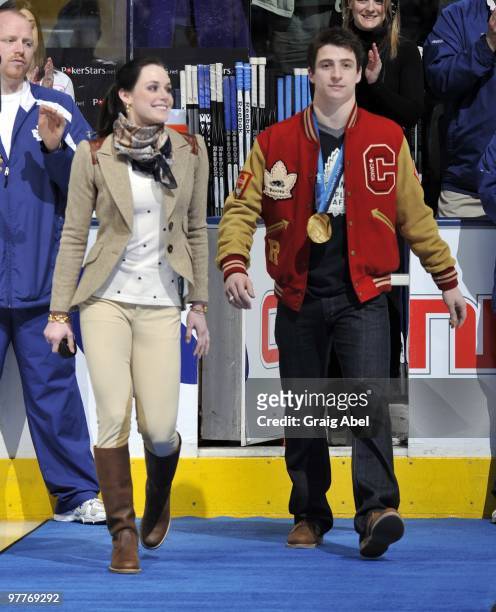 Olympians Tessa Virtue and Scott Moir walk on to the ice during a pre-game ceremony before game action between the Toronto Maple Leafs and Edmonton...