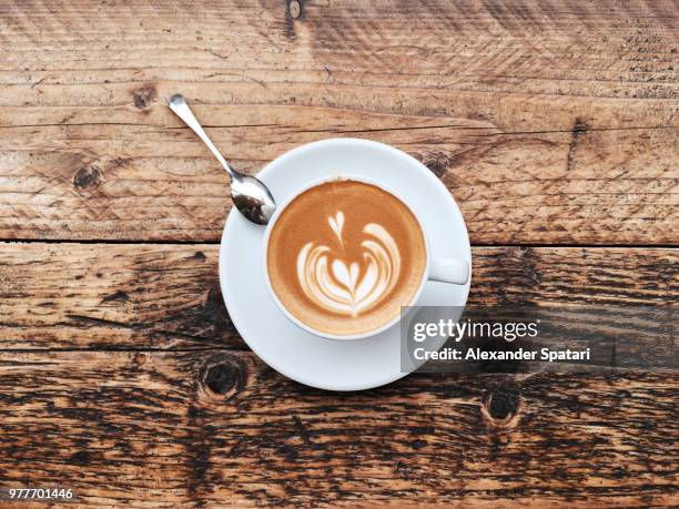 cup of cappuccino with latte art, directly above view - latte art ストックフォトと画像