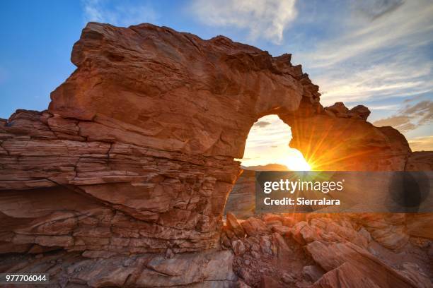 sunset through arsenic arch near hanksville, utah, america, usa - san rafael desert stock pictures, royalty-free photos & images