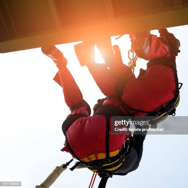 rescue team in action practicing in climbing equipment . rescue concept. - rope high rescue photos et images de collection