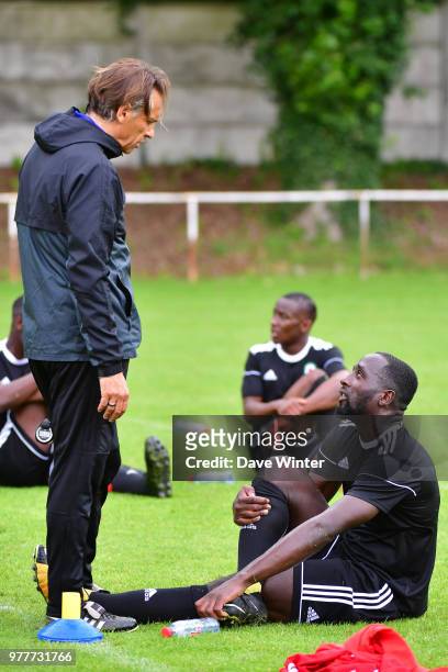 Edson Seidou of Red Star and Red Star coach Regis Brouard during the first training session of the new season for Red Star on June 18, 2018 in Paris,...