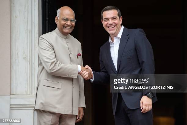 Greek Prime Minister Alexis Tsipras shakes hands with India's President Ram Nath Kovind at the Maximos Mansion in Athens on June 18, 2018 as Kovind...