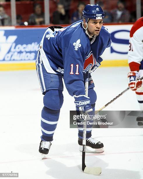 Owen Nolan of the Quebec Nordiques skates against the Montreal Canadiens in the early 1990's at the Montreal Forum in Montreal, Quebec, Canada.