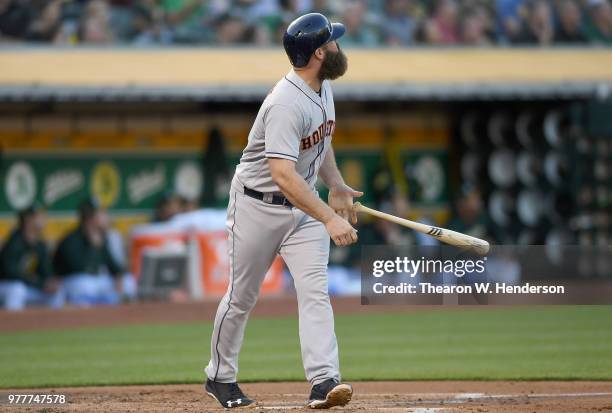 Evan Gattis of the Houston Astros hits a three-run home run against the Oakland Athletics in the top of the second inning at the Oakland Alameda...