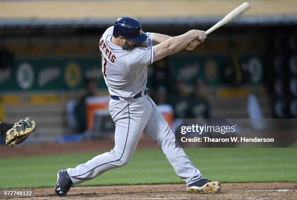 Evan Gattis of the Houston Astros bats against the Oakland Athletics in the top of the fifth inning at the Oakland Alameda Coliseum on June 12, 2018...