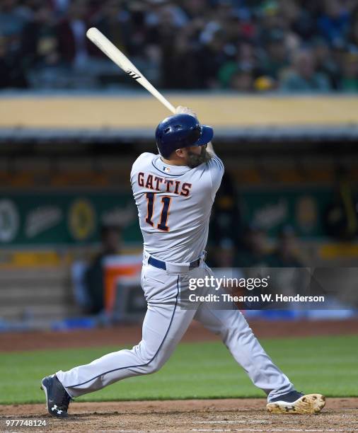 Evan Gattis of the Houston Astros bats against the Oakland Athletics in the top of the fifth inning at the Oakland Alameda Coliseum on June 12, 2018...