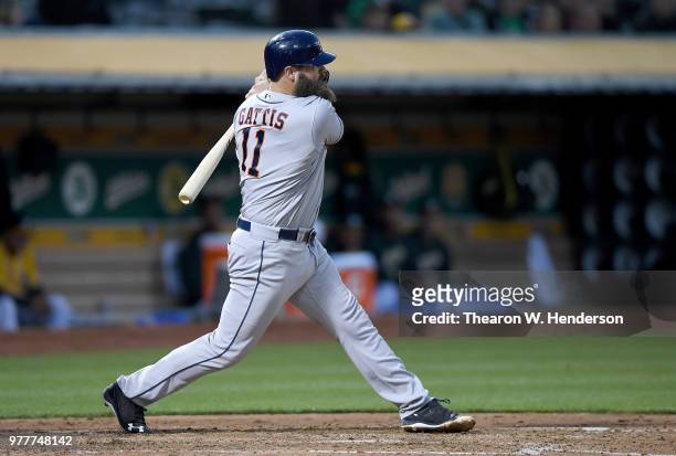 Evan Gattis of the Houston Astros bats against the Oakland Athletics in the top of the fifth inning at the Oakland Alameda Coliseum on June 12, 2018...