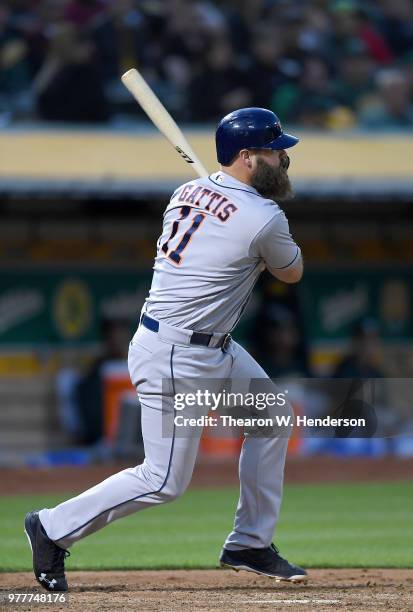 Evan Gattis of the Houston Astros hits a two-run rbi double against the Oakland Athletics in the top of the fifth inning at the Oakland Alameda...