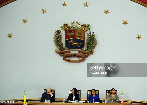 Belarussian President Alexander Lukashenko listens to a speech beside National Assembly president Cilia Flores, Supreme Court of Justice president...