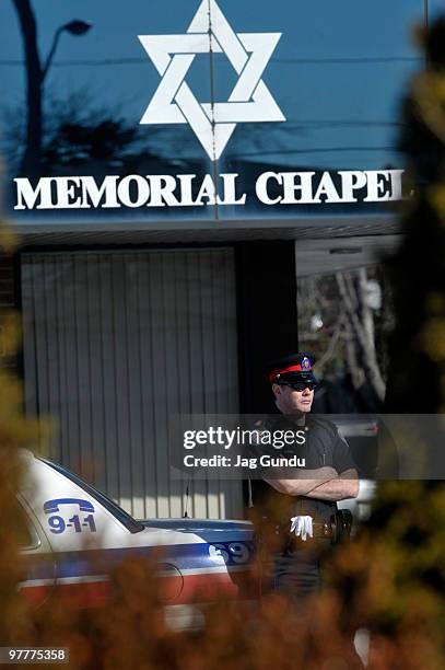 Police officer stands by as mourners attend the private funeral service for actor Corey Haim at Steeles Memorial Chapel on March 16, 2010 in...
