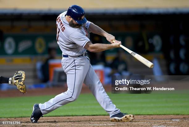 Evan Gattis of the Houston Astros hits a two-run rbi double against the Oakland Athletics in the top of the fifth inning at the Oakland Alameda...