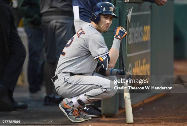 Josh Reddick of the Houston Astros looks on from the dugout against the Oakland Athletics in the top of the fifth inning at the Oakland Alameda...