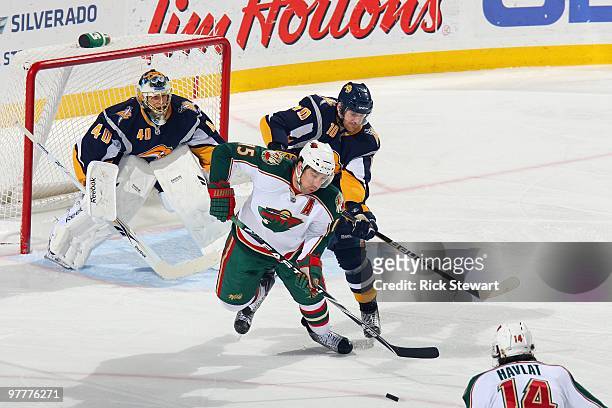 Andrew Brunette of the Minnesota Wild handles the puck against Henrik Tallinder of Buffalo Sabres at HSBC Arena on March 12, 2010 in Buffalo, New...