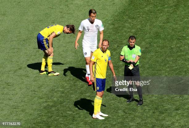 Referee Joel Aguilar shows a yellow card to Kim Shin-Wook of Korea Republic during the 2018 FIFA World Cup Russia group F match between Sweden and...