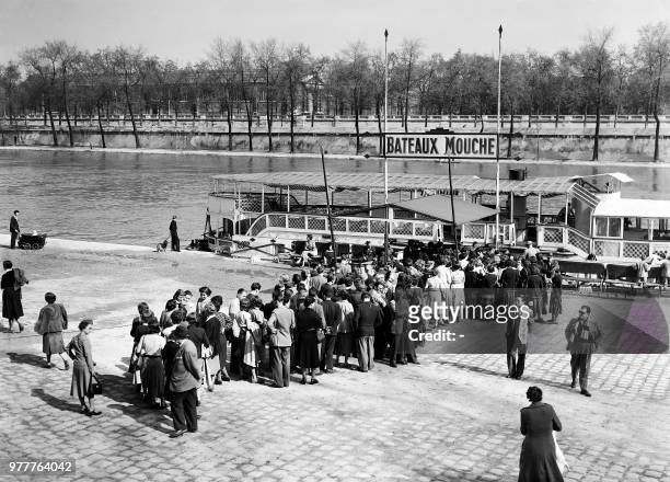 Picture taken on April 13, 1952 at Paris showing tourists waiting for a pleasure boat in order to make a ride on the river in the French capital.