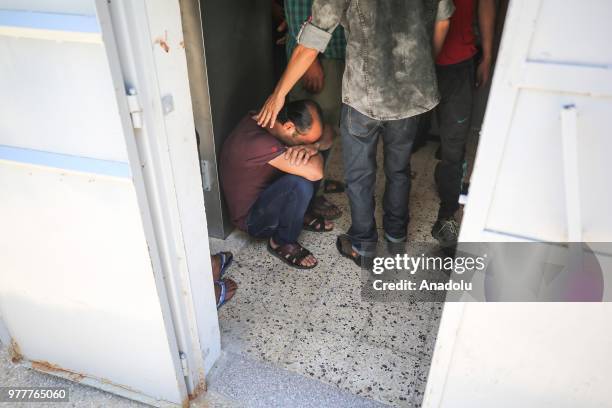 Relatives of Palestinian Sabry Ahmed Abu Khedr mourn as they gather in front of the Al Shifa Hospital after he was killed by Israeli forces, on June...