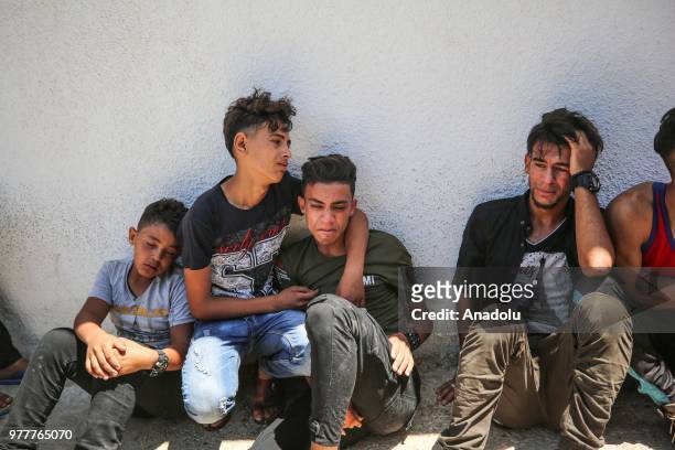 Relatives of Palestinian Sabry Ahmed Abu Khedr mourn as they gather in front of the Al Shifa Hospital after he was killed by Israeli forces, on June...