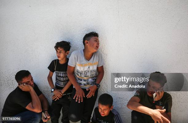 Relatives of Palestinian Sabry Ahmed Abu Khedr mourn as they gather in front of the Al Shifa Hospital after he was killed by Israeli forces, on June...