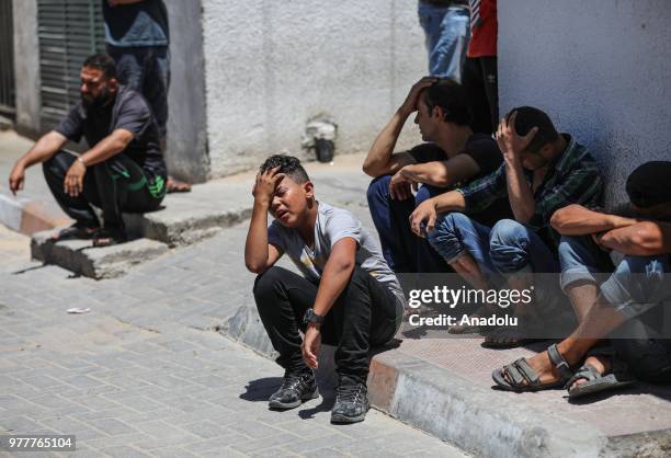 Relatives of Palestinian Sabry Ahmed Abu Khedr mourn as they gather in front of the Al Shifa Hospital after he was killed by Israeli forces, on June...