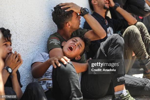 Relatives of Palestinian Sabry Ahmed Abu Khedr mourn as they gather in front of the Al Shifa Hospital after he was killed by Israeli forces, on June...