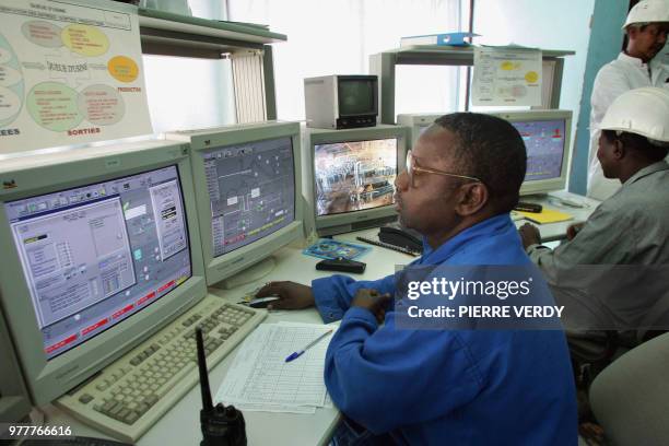 Technicians work on computers at the uranium opencast mine in Arlit in the Air desert, Niger, 23 February 2005, one of the world's most impoverished...