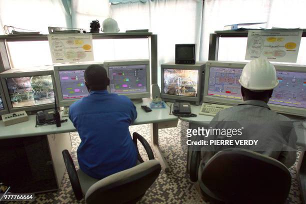 Technicians work on computers at the uranium opencast mine in Arlit in the Air desert, Niger, 23 February 2005, one of the world's most impoverished...