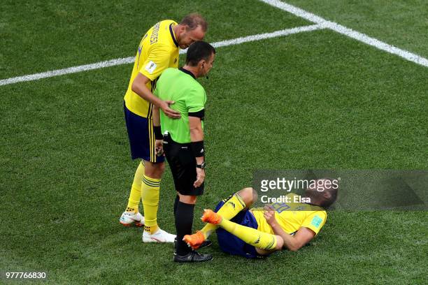Andreas Granqvist of Sweden speaks with Referee Joel Aguilar as Ola Toivonen of Sweden goes down during the 2018 FIFA World Cup Russia group F match...