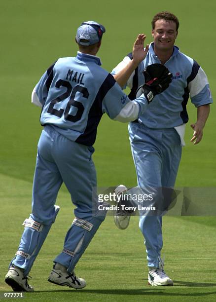 Bowler Stuart Clark celebrates with keeper Greg Mail as he takes the first wicket of the match, David Fitzgerald caught Stuart MacGill for 18 in the...