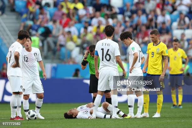 Referee Joel Aguilar checks if Koo Ja-Cheol of Korea Republic is ok as he goes down injured during the 2018 FIFA World Cup Russia group F match...