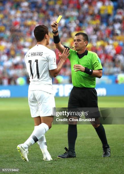 Hwang Hee-chan of Korea Republic is shown a yellow card by referee with Referee Joel Aguilar during the 2018 FIFA World Cup Russia group F match...