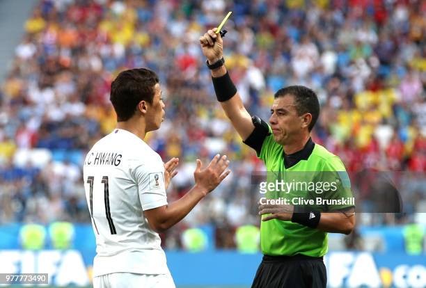 Hwang Hee-chan of Korea Republic is shown a yellow card by referee with Referee Joel Aguilar during the 2018 FIFA World Cup Russia group F match...