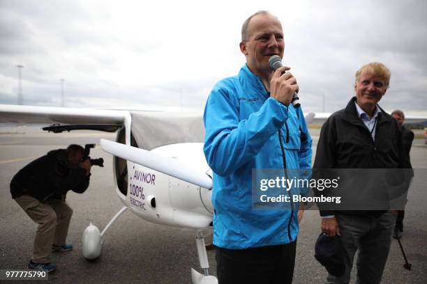 Ketil Solvik-Olsen, Norway's transport minister, left, speaks while standing beside an Avinor AS Alpha Electro G2 electric two-seater plane with Dag...
