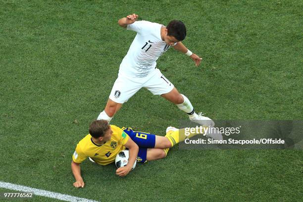 Ludwig Augustinsson of Sweden grabs for the ball as he anticipates a decision against Hwang Hee-chan of South Korea during the 2018 FIFA World Cup...