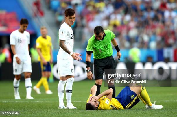 Jang Hyun-Soo of Korea Republic reacts as Marcus Berg of Sweden goes down, whilst Referee Joel Aguilar checks if he is ok during the 2018 FIFA World...