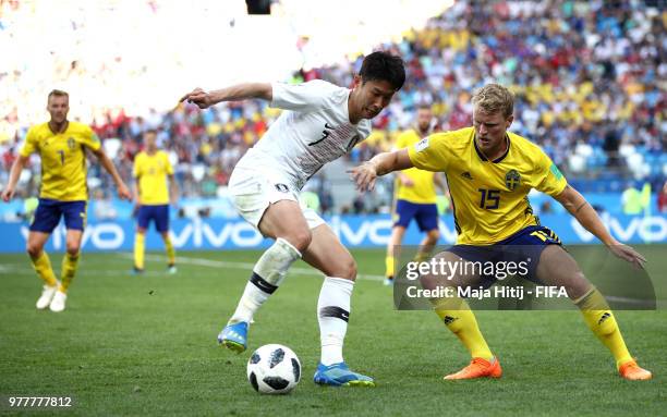 Son Heung-Min of Korea Republic challenge for the ball with Oscar Hiljemark of Sweden during the 2018 FIFA World Cup Russia group F match between...