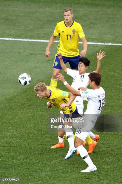 Oscar Hiljemark of Sweden heads the ball under pressure from Lee Seung-Woo of Korea Republic and Jung Woo-Young of Korea Republic during the 2018...