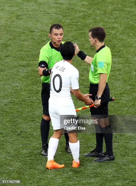 Lee Seung-Woo of Korea Republic appeals to Referee Joel Aguilar and fourth official during the 2018 FIFA World Cup Russia group F match between...