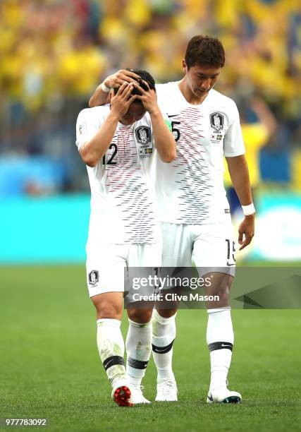 Kim Min-Woo and team mate Jung Woo-Young of Korea Republic look dejected following the 2018 FIFA World Cup Russia group F match between Sweden and...