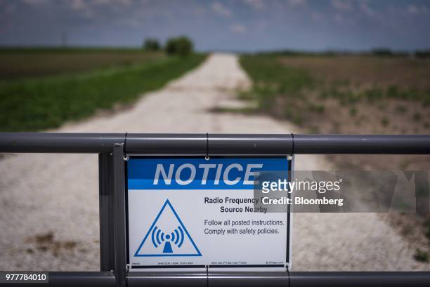 Sign near data transmission towers notes the presence of radio frequency energy nearby in Maple Park, Illinois, U.S., on Friday, May 25, 2018. In...