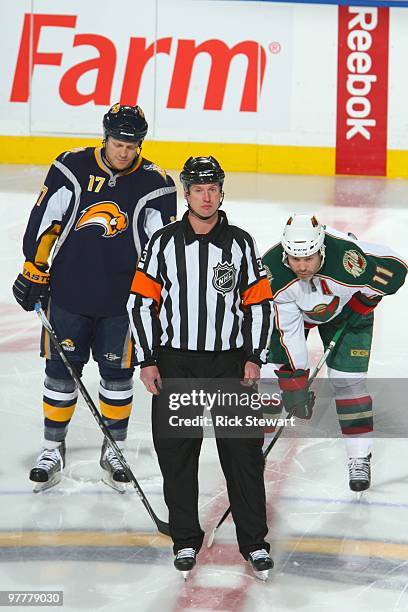 Referee Chris Lee looks on before Raffi Torres of the Buffalo Sabres gets ready to face off against Owen Nolan of the Minnesota Wild at HSBC Arena on...