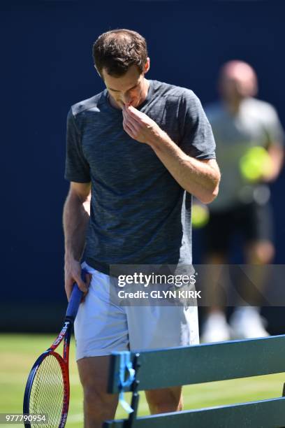 Britain's Andy Murray gestures during practice, ahead of his first round match at the ATP Queen's Club Championships tennis tournament in west London...