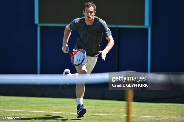 Britain's Andy Murray runs to the net during practice, ahead of his first round match at the ATP Queen's Club Championships tennis tournament in west...
